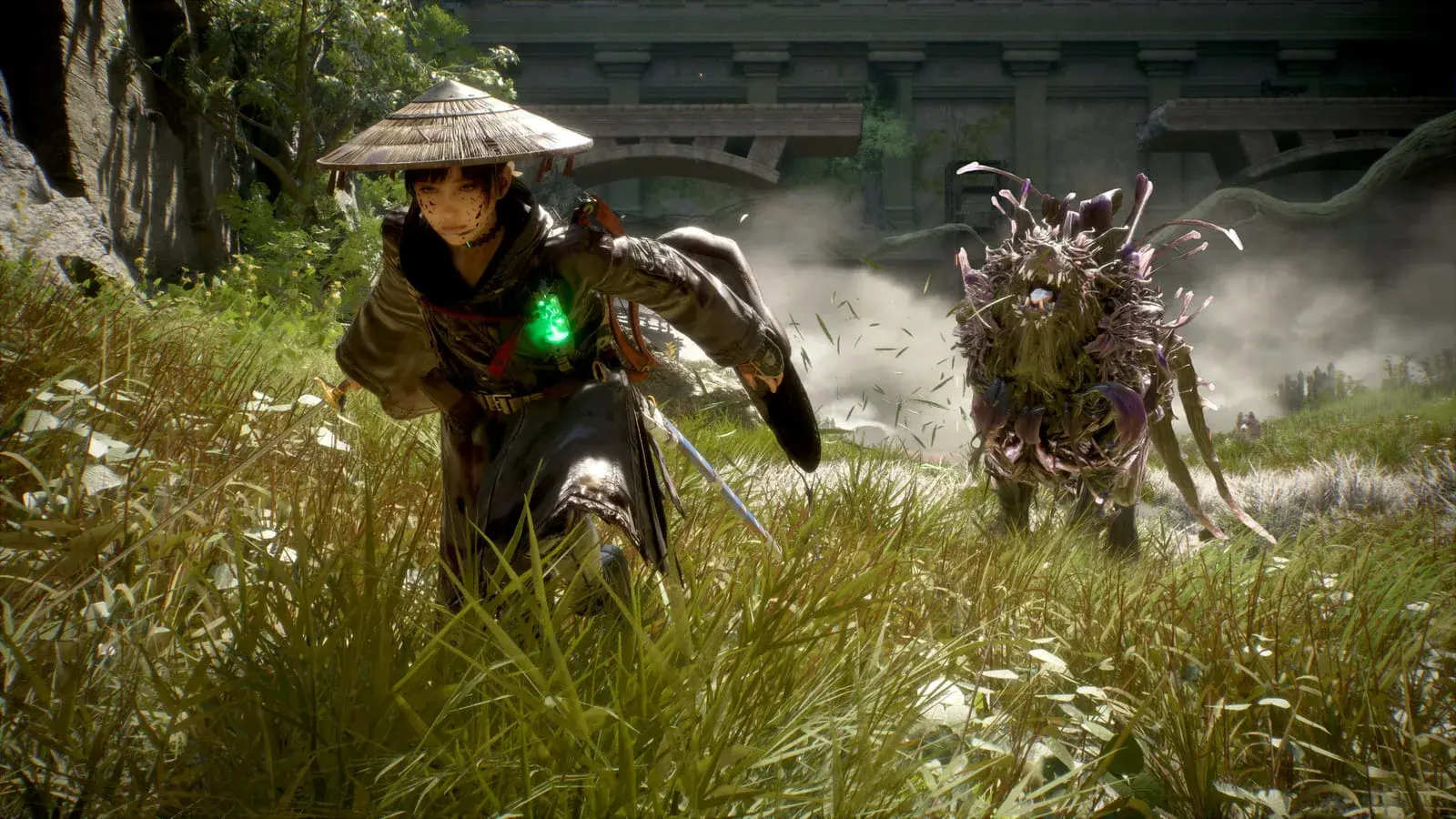 A green charm glowing at Emma’s chest as she closes on a plant-covered creature in tall grass